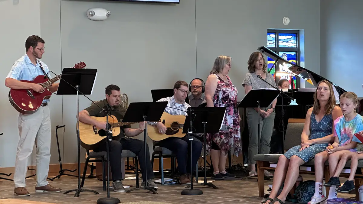 The praise band leading worship with guitars and singers.