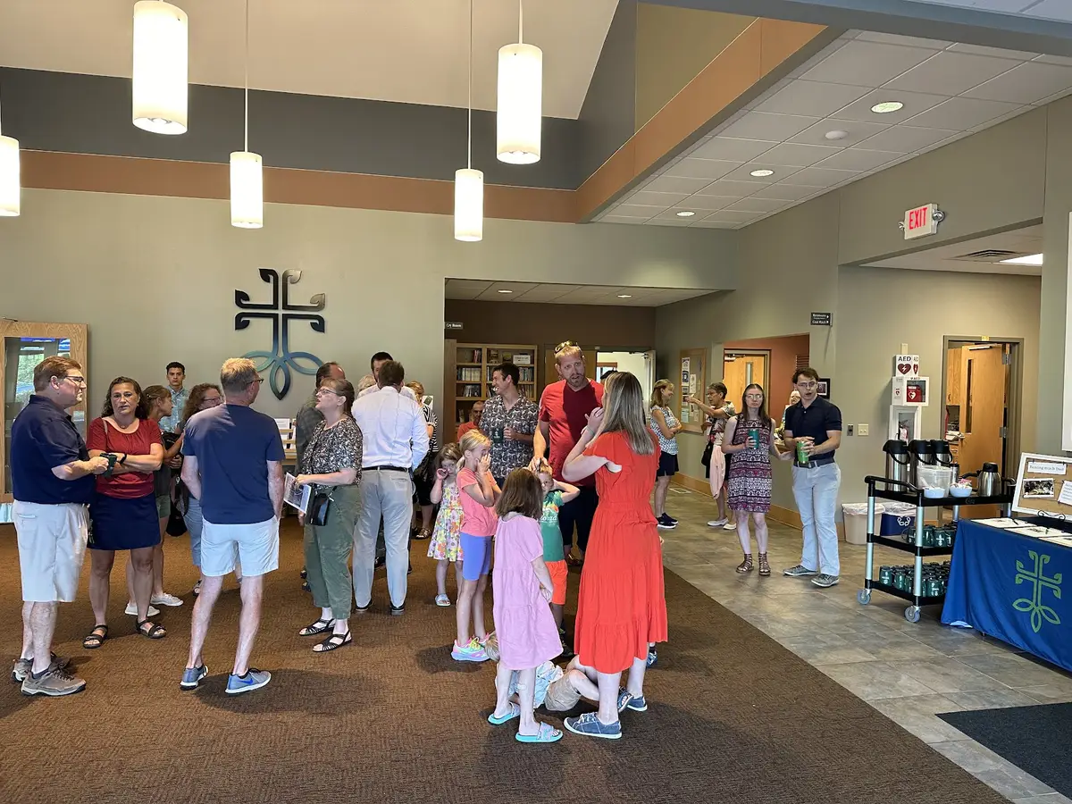 Members and families visiting over coffee in the Gathering Space.