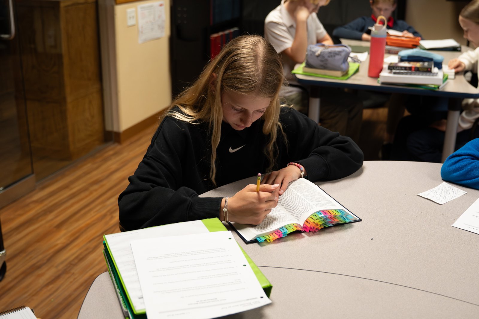 A student marking up her Bible